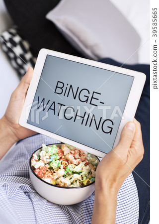 man and tablet, with the text binge-watching in it 39585665