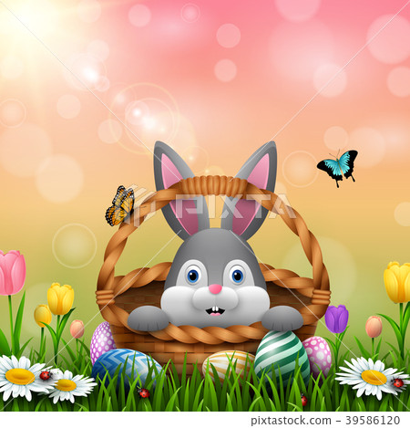 Cute Easter bunny in a basket with colorful eggs o Cute Easter bunny in a basket with colorful eggs o 39586120