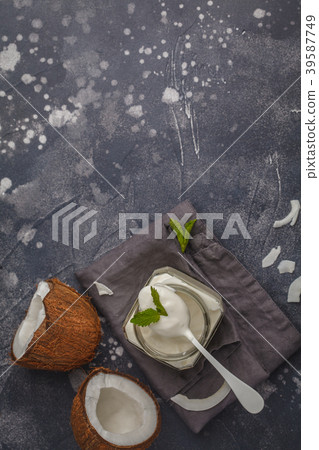 Coconut yogurt in a glass jar on a dark background 39587749