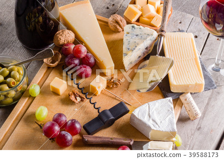 Palette of many types of cheese and some grapes Palette of many types of cheese and some grapes 39588173