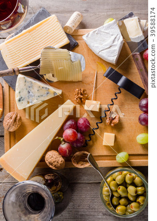 Palette of many types of cheese and some grapes Palette of many types of cheese and some grapes 39588174