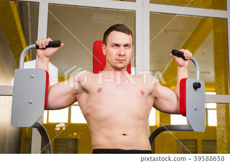 Young handsome man training in gym Young handsome man training in gym 39588658