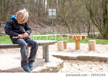 A boy carving and playing with with woodblock 39591344