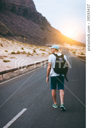 Traveler with backpack walks in the center of an 39593437