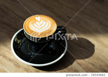 Close up hot black coffee cup with latte art Close up hot black coffee cup with latte art 39593662