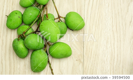 Green sour mango (raw mango) on a wooden table. 39594500