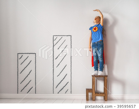 child is playing superhero 39595657