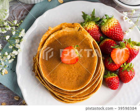 Stack of oatmeal pancakes with strawberries Stack of oatmeal pancakes with strawberries 39598384