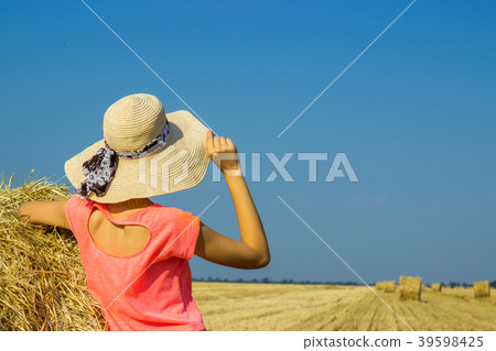 Happy woman on hay stack in sunny day. Happy woman on hay stack in sunny day. 39598425