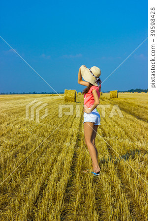 Happy woman on hay stack in sunny day. Happy woman on hay stack in sunny day. 39598428