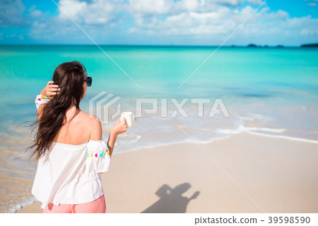 Young woman on the beach. Back view of girl with 39598590
