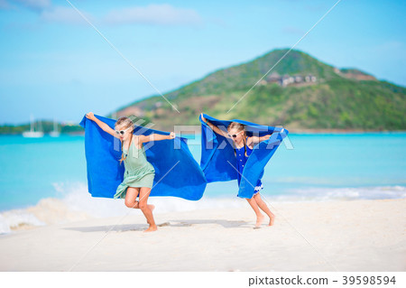 Cute little girls having fun running with towel 39598594