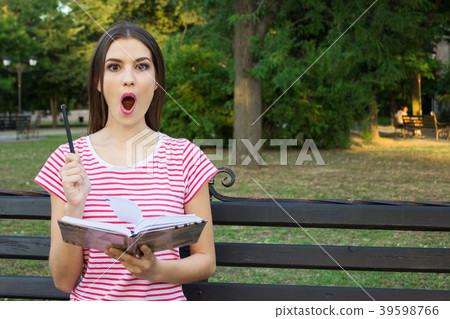 Young pretty girl holding a pen up having an idea Young pretty girl holding a pen up having an idea 39598766