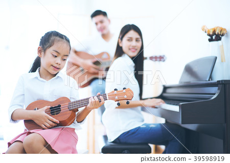 Asian daughter and parent be playing music 39598919