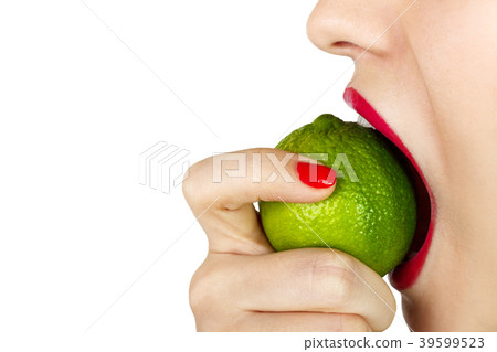 Young woman bite eat fresh lime isolated Young woman bite eat fresh lime isolated 39599523