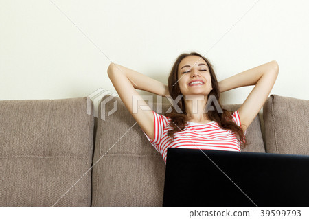 Asian girl relaxing at home with laptop Asian girl relaxing at home with laptop 39599793