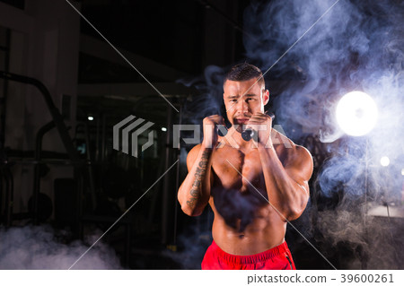 Powerful man doing boxing exercises, making direct Powerful man doing boxing exercises, making direct 39600261
