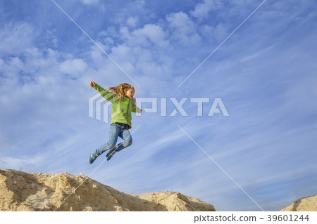 Little pretty girl jumping on sand beach 39601244
