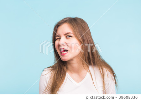 Red tablet in the mouth of the woman on blue 39608336