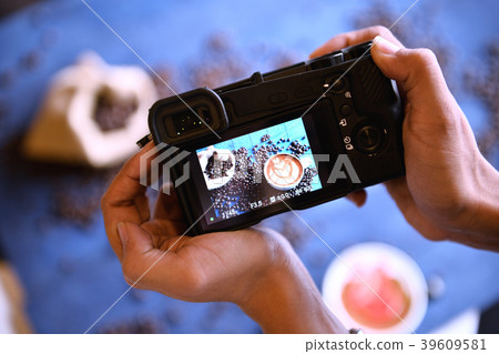 Behind the scene, place a cup of coffee on a beaut Behind the scene, place a cup of coffee on a beaut 39609581