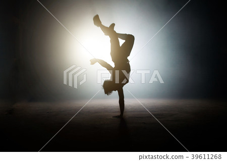 man showing a one-handed handstand with legs on man showing a one-handed handstand with legs on 39611268