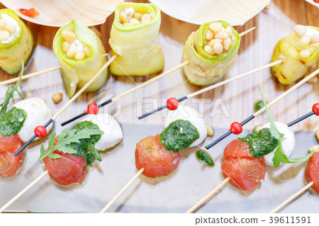 Zucchini rolls with pine nuts. Cherry tomatoes 39611591