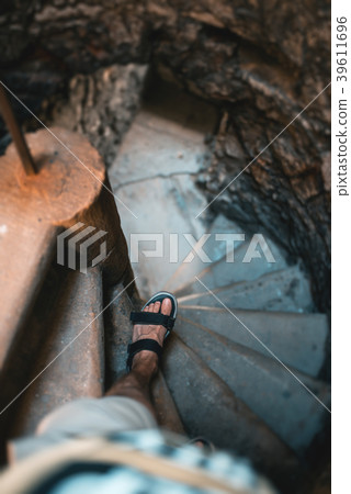 Man goes down the stairs, medieval castle interior 39611696