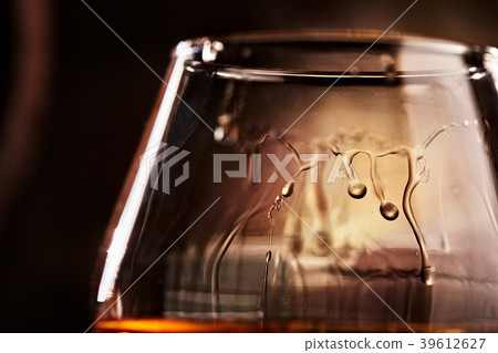 glass with cognac closeup.taste of cognac. glass with cognac closeup.taste of cognac. 39612627