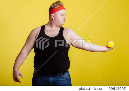 fat man with dumbbell on yellow background 39613605