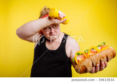 Fatigued fat man sweats while lifting burger Fatigued fat man sweats while lifting burger 39613638