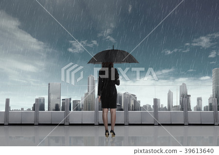 Business woman with umbrella in the rain Business woman with umbrella in the rain 39613640