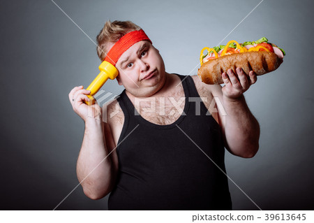 fat man looking at camera and holding burger and fat man looking at camera and holding burger and 39613645