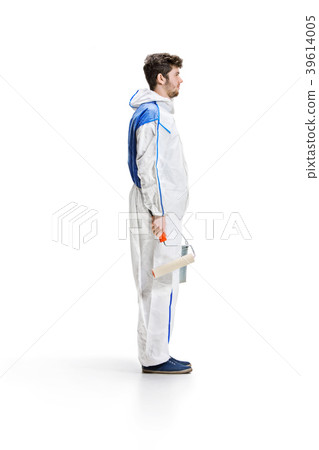 Young male decorator painting with a paint roller Young male decorator painting with a paint roller 39614005