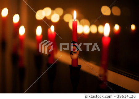 Golden light of candle flame 39614126