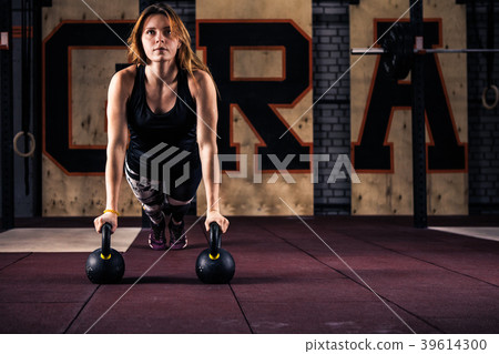 Attractive young gym fitness woman doing push-ups Attractive young gym fitness woman doing push-ups 39614300