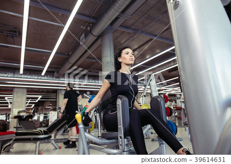 Adduction or abductor machine. girl exercising her Adduction or abductor machine. girl exercising her 39614631