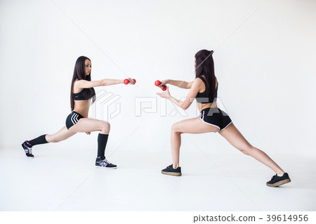 Two beautiful sportive girl friends in sportsuits Two beautiful sportive girl friends in sportsuits 39614956
