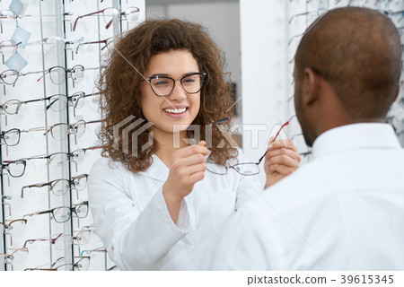 Backview of man trying on eyeglasses in optical 39615345