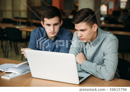 Two boy student use laptop in library Two boy student use laptop in library 39615796