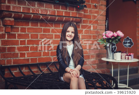 girl sitting near bricks wall background girl sitting near bricks wall background 39615920