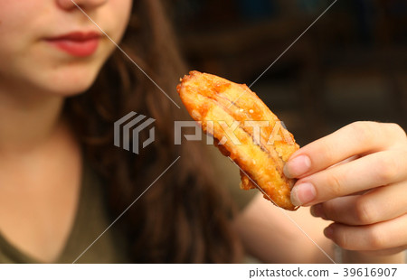 roasted sweet mini banana in teen girl hand close up photo roasted sweet mini banana in teen girl hand close up photo 39616907