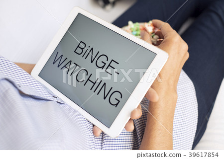 man and tablet, with the text binge-watching in it 39617854