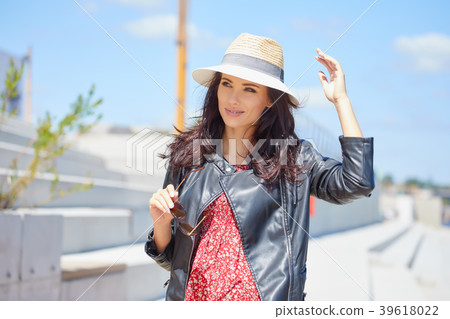 Portrait of happy smiling woman standing on the square on sunny Portrait of happy smiling woman standing on the square on sunny 39618022