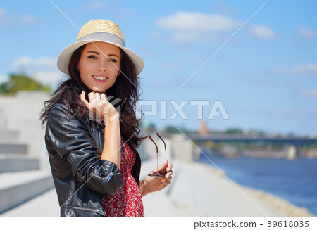 Portrait of happy smiling woman standing on the square on sunny 39618035