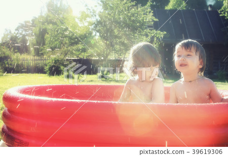 baby splashing in the pool outdoors baby splashing in the pool outdoors 39619306