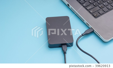 Black external hard disk connecting to a laptop Black external hard disk connecting to a laptop 39620913