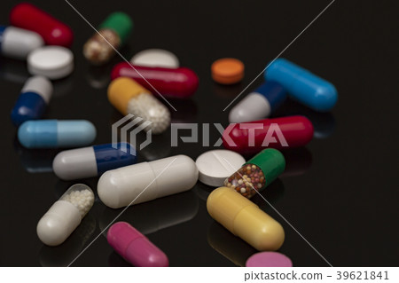 Heap of colorful drugs and pills on black 39621841