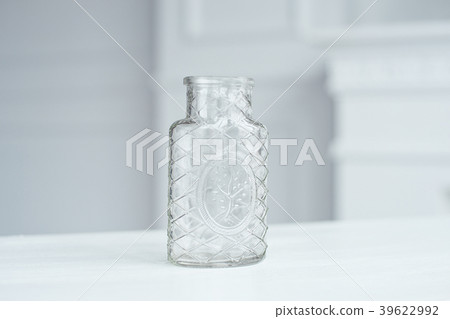 Clear Glass Bottle Vase on white table Clear Glass Bottle Vase on white table 39622992