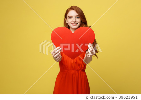 Portrait happy woman holding a heart symbol on Portrait happy woman holding a heart symbol on 39623951