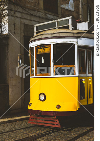 Quaint yellow tram on the rails of old and 39623959
